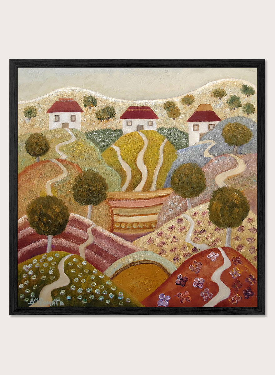 A framed landscape painting featuring stylized rolling hills, winding paths, small houses with red roofs, and trees. Shop Charming Hillside Village by Angeles M. Pomata, a colorful countryside art print featuring winding paths, red-roof houses, flowering fields, and warm autumn tones.