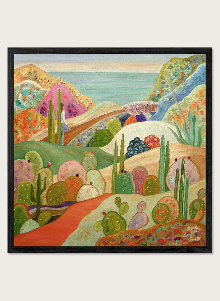 A framed colorful landscape painting featuring stylized cacti, hills, and a coastal scene. Shop Colorful Desert Yoga View by Angeles M. Pomata, a colorful desert landscape art print featuring cacti, rolling hills, a yoga figure, and coastal views.