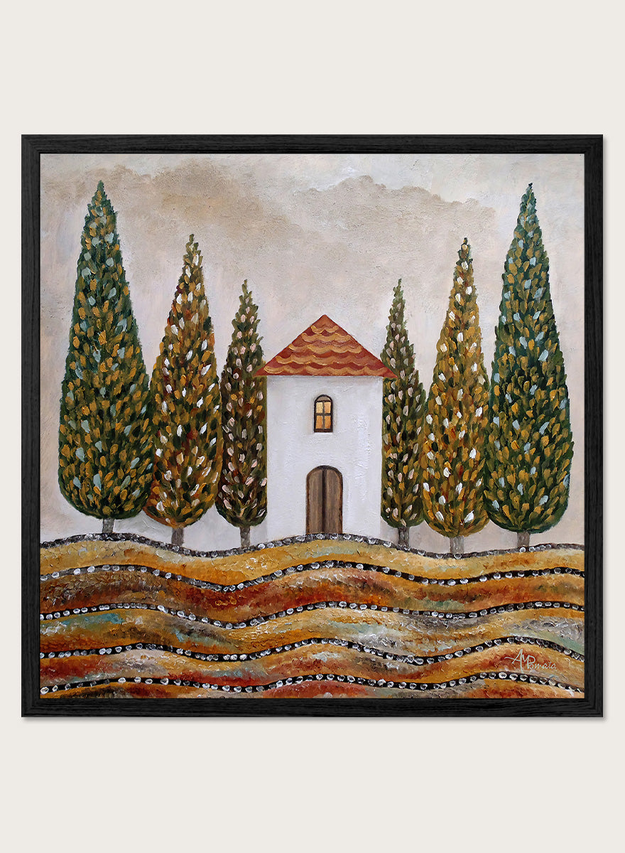 A framed landscape art print depicting a small white house with a red-tiled roof, surrounded by tall green cypress trees and wavy golden-brown hills. Shop Tuscan Cypress House by Angeles M. Pomata, an autumn landscape art print featuring a white country house, tall cypress trees, terracotta roof, and warm earthy tones.