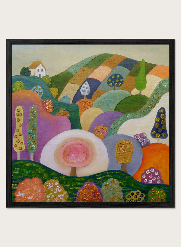 A colorful abstract landscape painting in a black frame, featuring stylized hills, trees, flowers, and a small house. The artwork has a playful, patchwork-like design with multiple vibrant colors including green, purple, orange, pink, blue, and yellow, set against a light beige wall. Shop Whimsical Hillside Village by Ángeles M. Pomata, a colorful landscape art print with rolling hills, patterned trees, and a dreamy village feel.