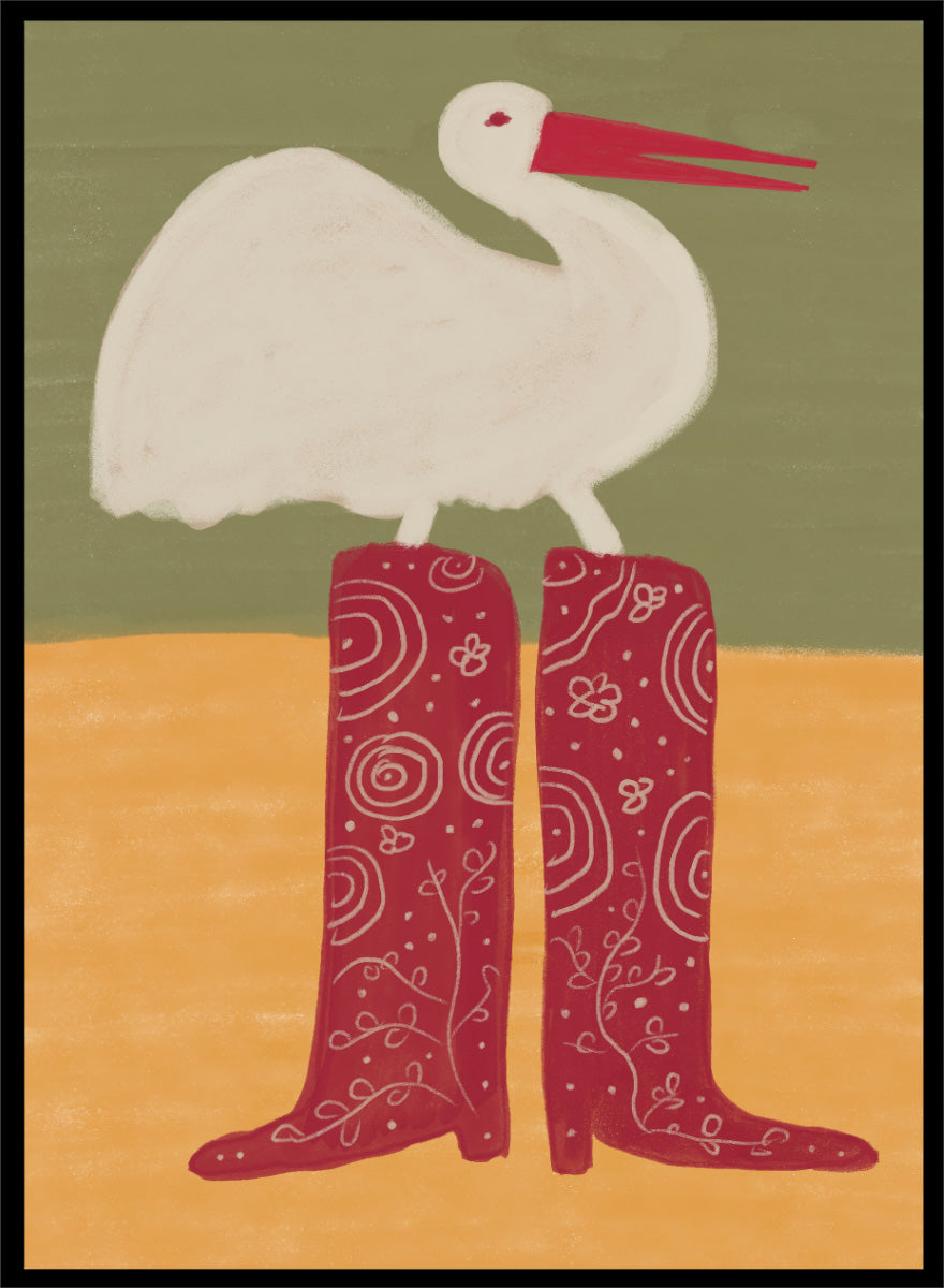 A stylized art print featuring a white stork with a red beak standing on a pair of tall red boots with white swirl patterns, set against a muted green and ochre background. Bird in Red Boots by The Art Concept playful animal art print featuring a white bird in oversized red patterned boots with soft green and ochre tones.