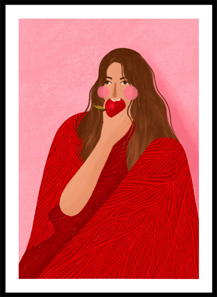 A framed art print featuring a stylized illustration of a woman with long brown hair, wearing a red patterned wrap, holding a red apple to her lips, set against a pink background. Cozy Woman Apple by Bea Müller portrait art print featuring a woman eating a red apple in bold red and pink tones for colorful modern wall decor.