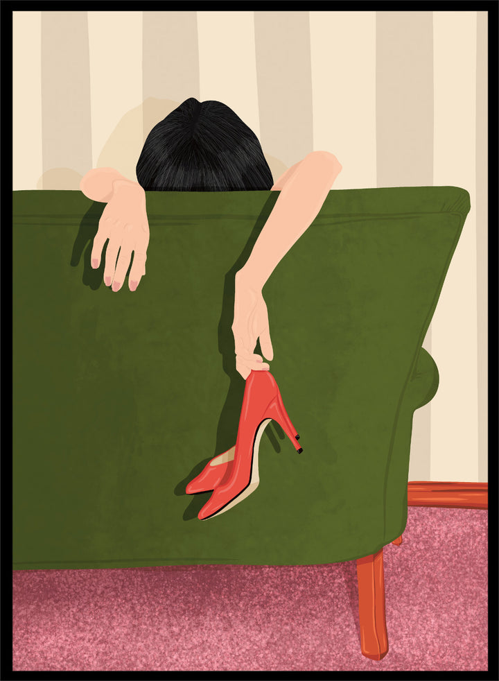 A stylized illustration of a person sitting on a green sofa, holding a pair of red high-heeled shoes. The person has dark hair and pale skin, with striped beige walls and a pink carpet in the background. Woman Resting Red Heels by Lisa Solomoniuk premium framed fine art print featuring a woman draped over a green chair holding bright red heels.