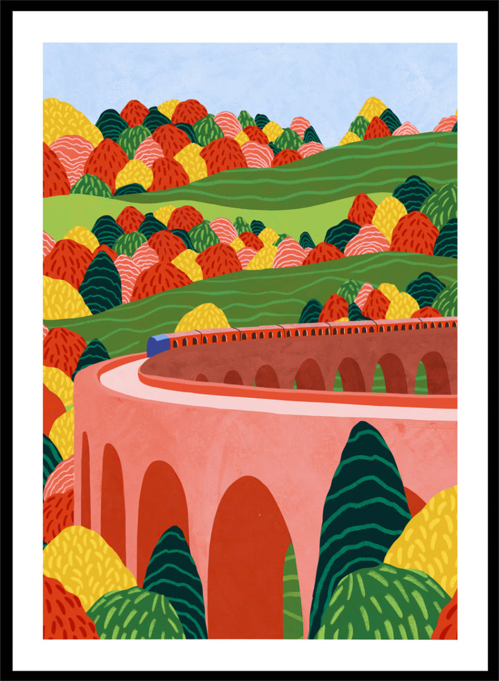 A framed art print featuring a stylized landscape illustration with rolling green hills, colorful patterned trees, and a pink arch bridge under a light blue sky. Winding Autumn Viaduct by Ceyda Alasar travel art print featuring a colorful train, arched bridge, rolling hills, and bold autumn foliage.