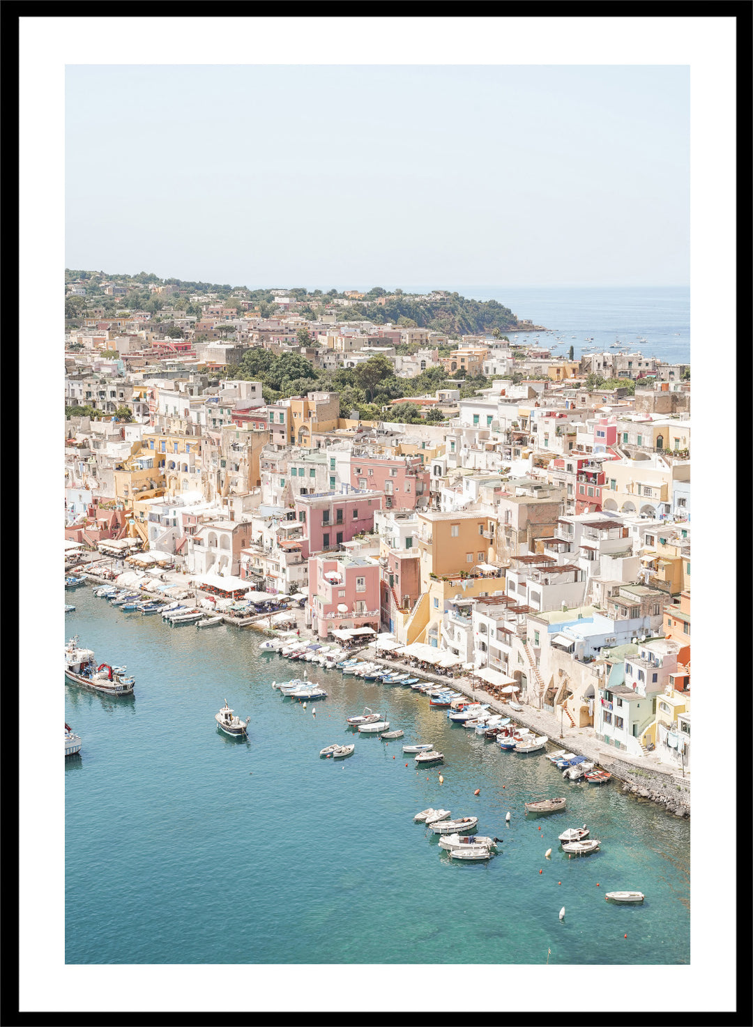 Coastal town with colorful buildings and boats in a harbor. Vibrant Italian Coastal Town by Henrike Schenk is a coastal photography print featuring pastel architecture, turquoise waters, fishing boats, and Mediterranean charm.