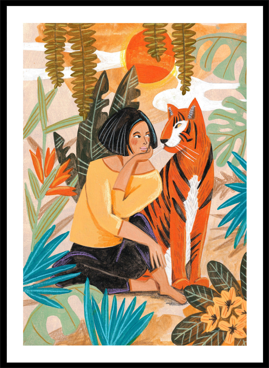A framed art print featuring a stylized illustration of a woman in a yellow top and black skirt sitting beside an orange tiger, surrounded by tropical leaves and a warm orange sky. Woman with Tiger by Caroline Bonne Müller tropical art print featuring a woman beside a tiger among lush foliage, bold color, and hand-drawn texture.