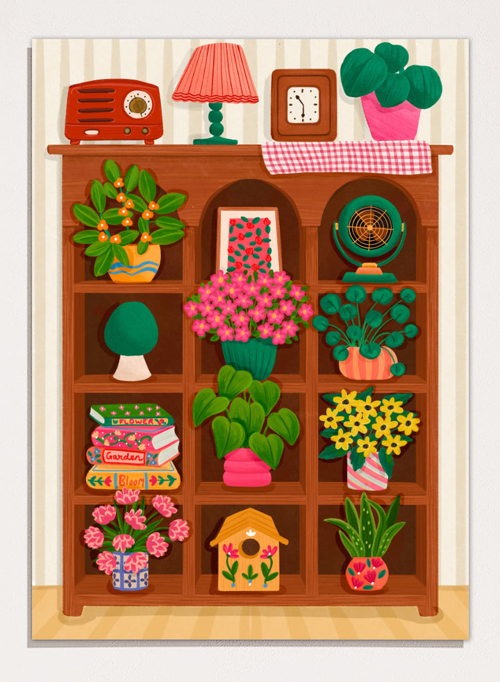 A colorful cartoon-style illustration of a wooden bookshelf filled with potted plants, flowers, books, a lamp, a clock, a radio, and other home decor items, set against a striped wall. Shop Cozy Botanical Shelf by Nidhi Kachhadiya, a colorful botanical wall art print featuring houseplants, flowers, vintage decor, and warm green and pink tones.