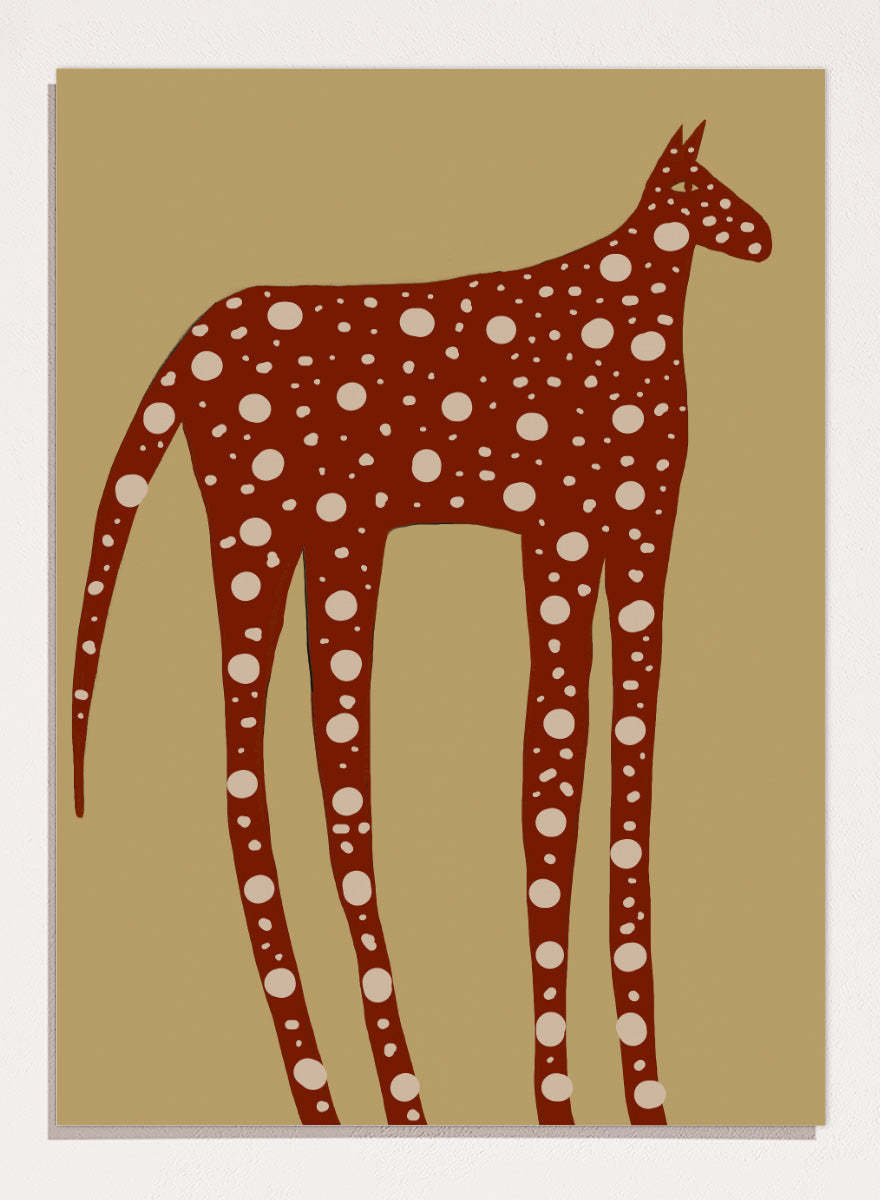 A stylized art print of a giraffe in reddish-brown with white spots, set against a tan background. Spotted Earthy Creature by The Art Concept animal art print featuring a long-legged rust-colored figure with cream spots on a muted tan background.