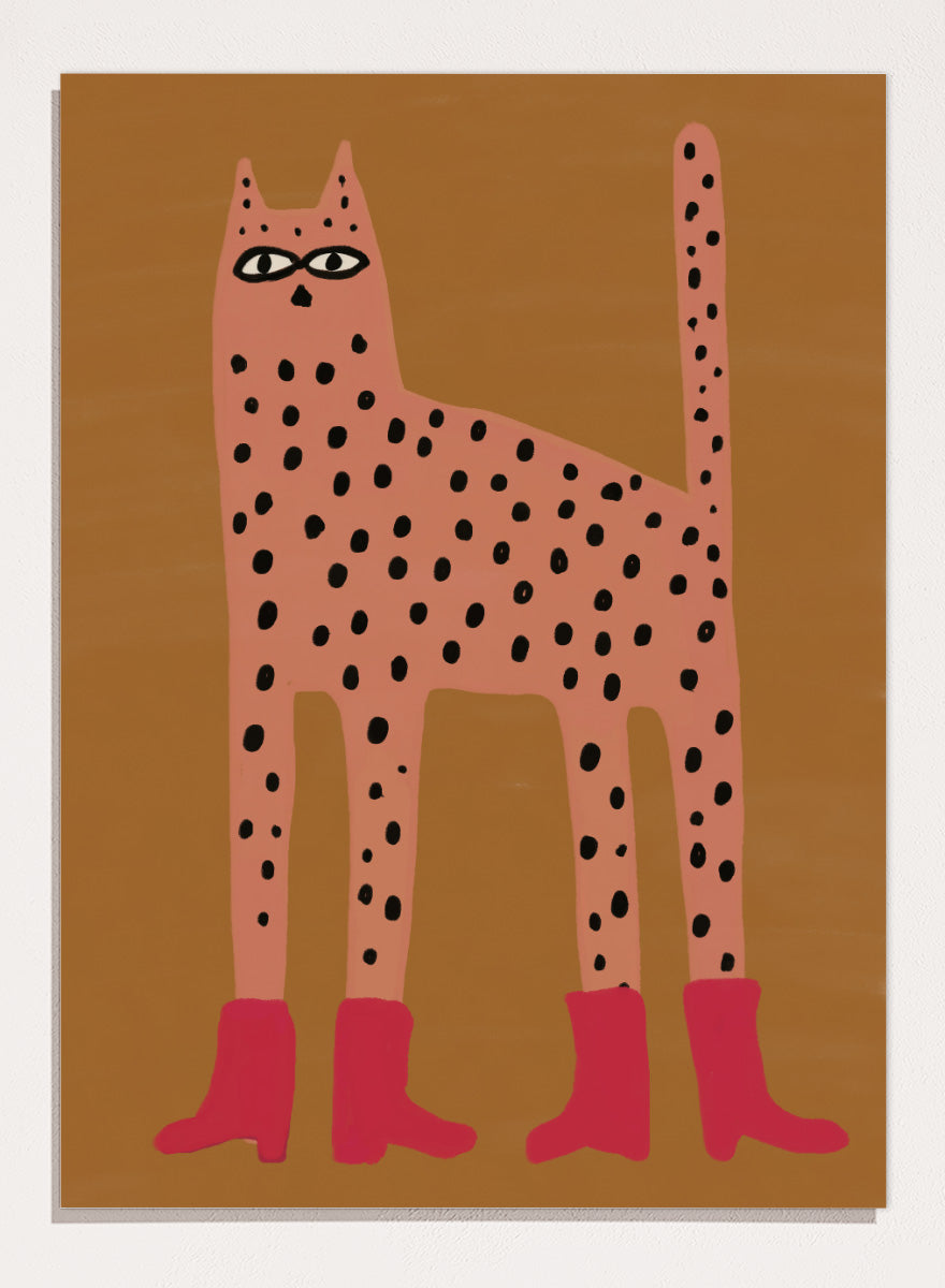 A stylized art print of a tall spotted cat in a pinkish-orange tone with black spots and bright pink boots, set against a warm brown background. Spotted Cat in Boots by The Art Concept playful cat art print featuring a pink spotted cat with long legs, red boots, and a warm ochre background.