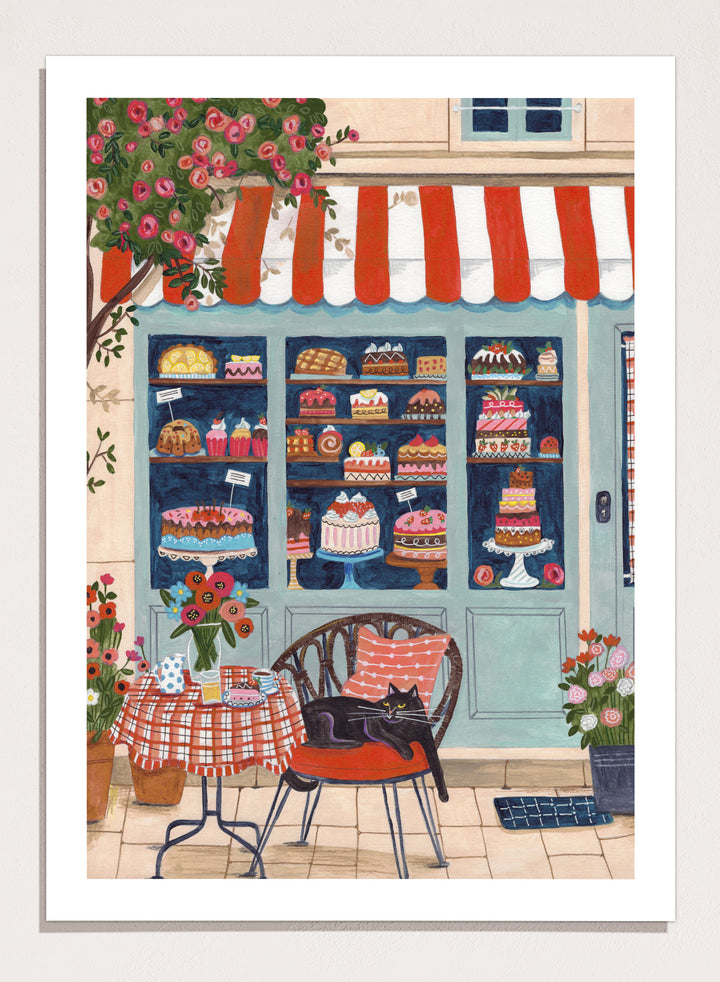 Illustration of a bakery with a cat sitting on a chair outside. Bakery Cat Cafe by Caroline Bonne Müller is a colorful bakery art print featuring cat illustration, pastry shop window, floral details, and modern aesthetic cafe scene.
