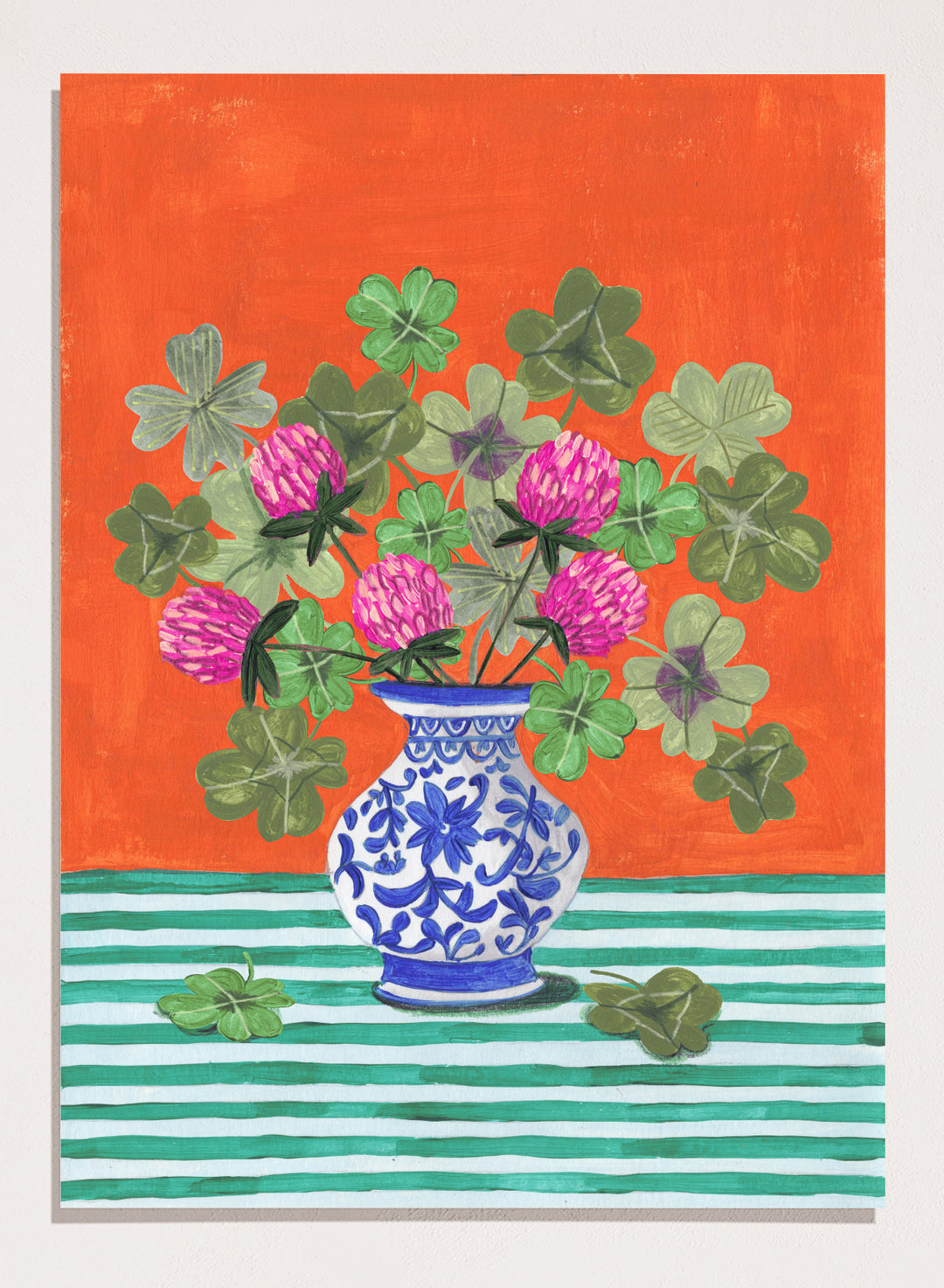 Vase with pink flowers and green leaves on a red and green striped background. Vibrant Clover Still Life by Caroline Bonne Müller is a fine art print and wall poster featuring clover leaves, pink flowers, and a blue vase on a striped table.