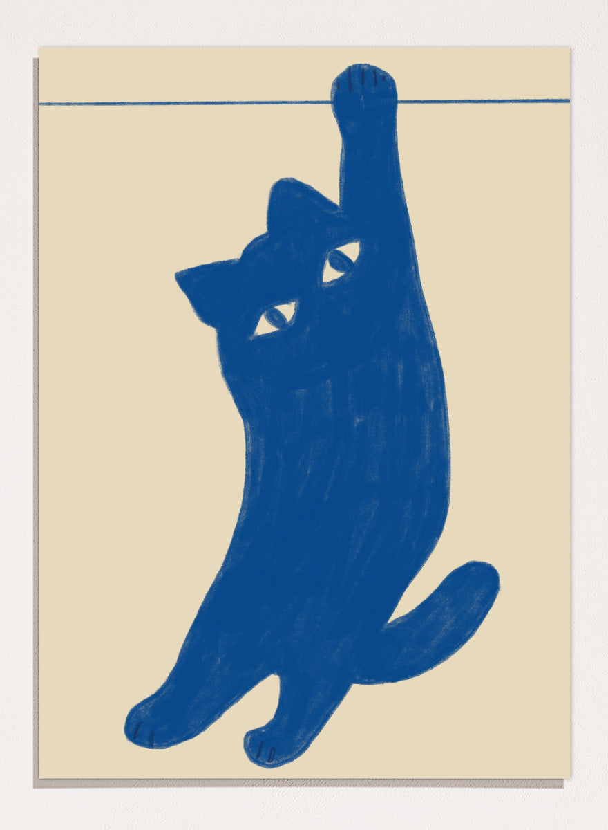 A stylized blue cat silhouette hanging from a thin horizontal line on a warm beige background. Hanging Blue Cat by The Art Concept is a playful cat art print featuring a blue cat dangling from one paw against a warm cream background.
