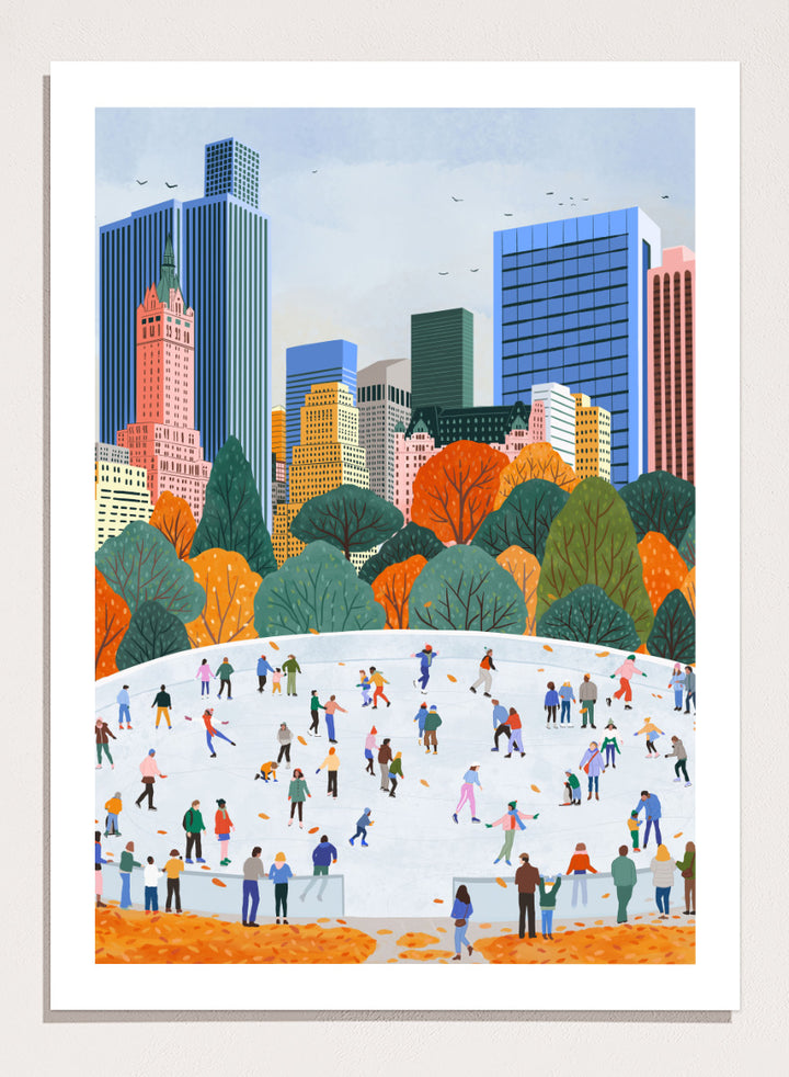 A framed art print depicting a city skyline with autumn trees and a large white ice rink filled with small illustrated people skating. Autumn City Ice Skating by Ceyda Alasar city art print featuring a lively outdoor rink, fall trees, skaters, and a colorful urban skyline.