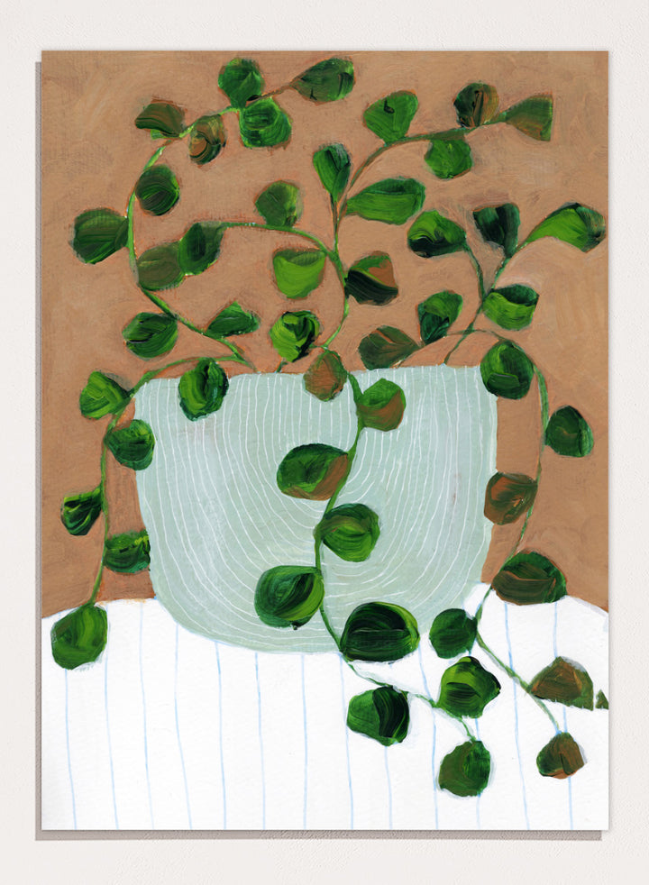 Shop Warm Houseplant Pot by Nikita Jariwala, a botanical wall art print poster featuring a trailing houseplant in a green pot with warm green tones.