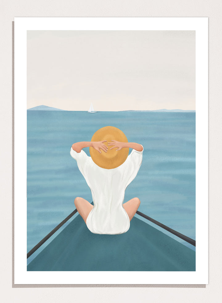 Person sitting on a dock over water wearing a white dress and straw hat. Ocean Escape by Flow Line features a woman sitting on a boat overlooking the sea, creating a coastal art print inspired by travel, summer, and ocean living.