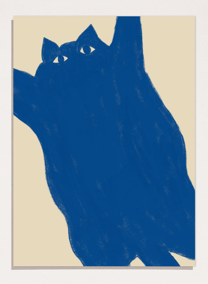 A minimalist art print featuring a bold blue cat silhouette with white eyes on a warm beige background. Playful Blue Cat by The Art Concept is a modern cat art print featuring a bold blue feline, oversized crop, and warm cream background.