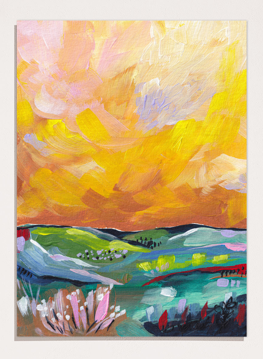 An abstract landscape painting featuring a dramatic yellow and orange sky over green and blue rolling hills, with textured brushstrokes. Shop Vibrant Sunset Landscape by Dirkie Nell, a colorful landscape art print featuring rolling green hills, wildflowers, and a warm golden sunset sky.