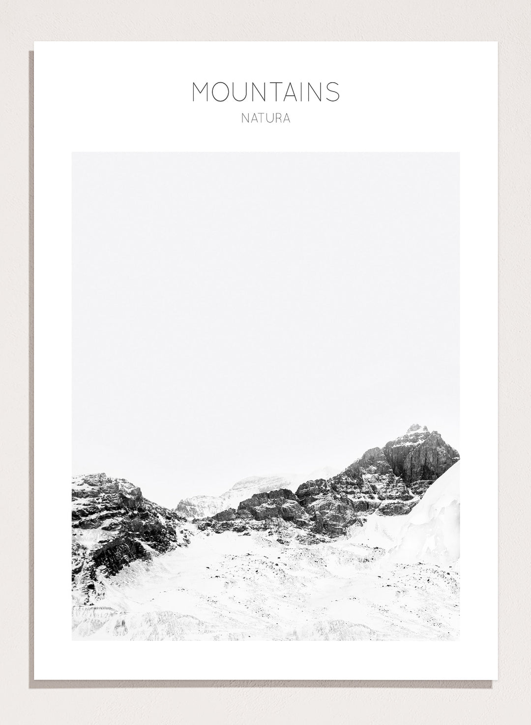 Black and white mountain landscape with 'Mountains Natura' text. Serene Peaks by The MIUUS Studio is a black and white mountain photography art print and wall poster featuring snowy peaks, minimalist composition, and modern neutral design.