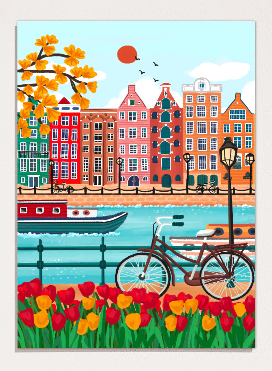 A colorful illustrated city canal scene with row houses, a bicycle, boats, flowers, and a bright sun.  Shop Colorful Amsterdam Canal by Nidhi Kachhadiya, a vibrant Amsterdam wall art print with canal houses, tulips, a bicycle, and colorful city charm.