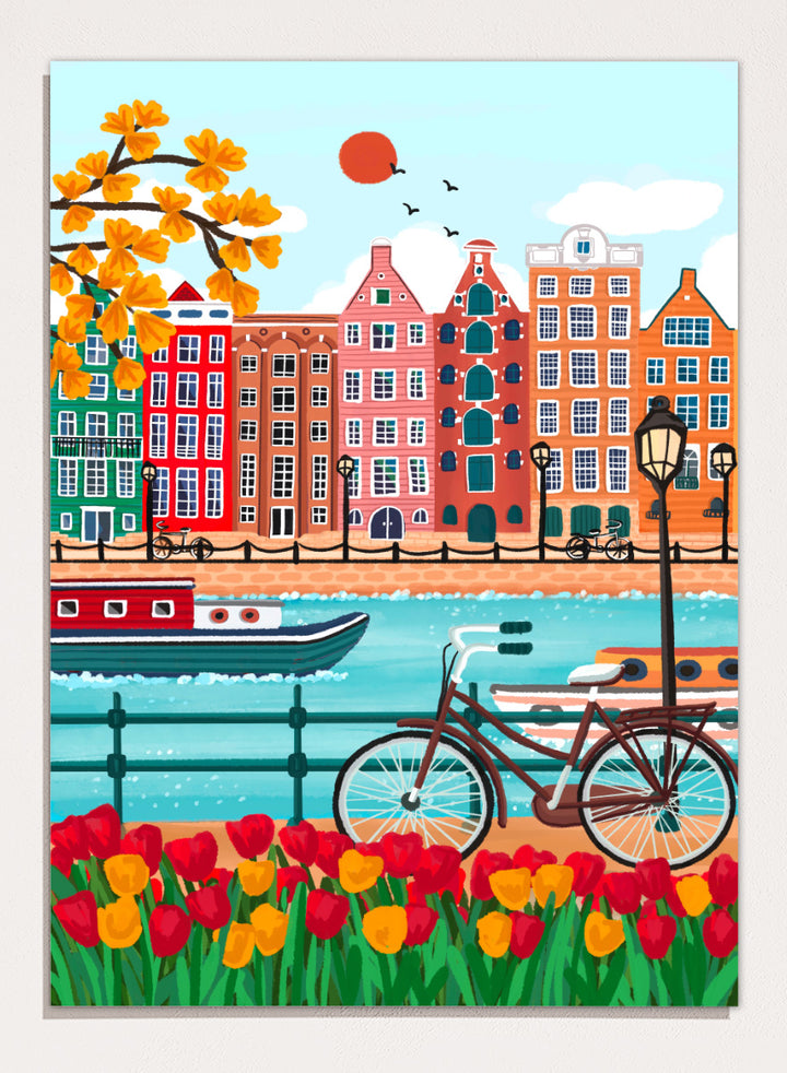 A colorful illustrated city canal scene with row houses, a bicycle, boats, flowers, and a bright sun.  Shop Colorful Amsterdam Canal by Nidhi Kachhadiya, a vibrant Amsterdam wall art print with canal houses, tulips, a bicycle, and colorful city charm.