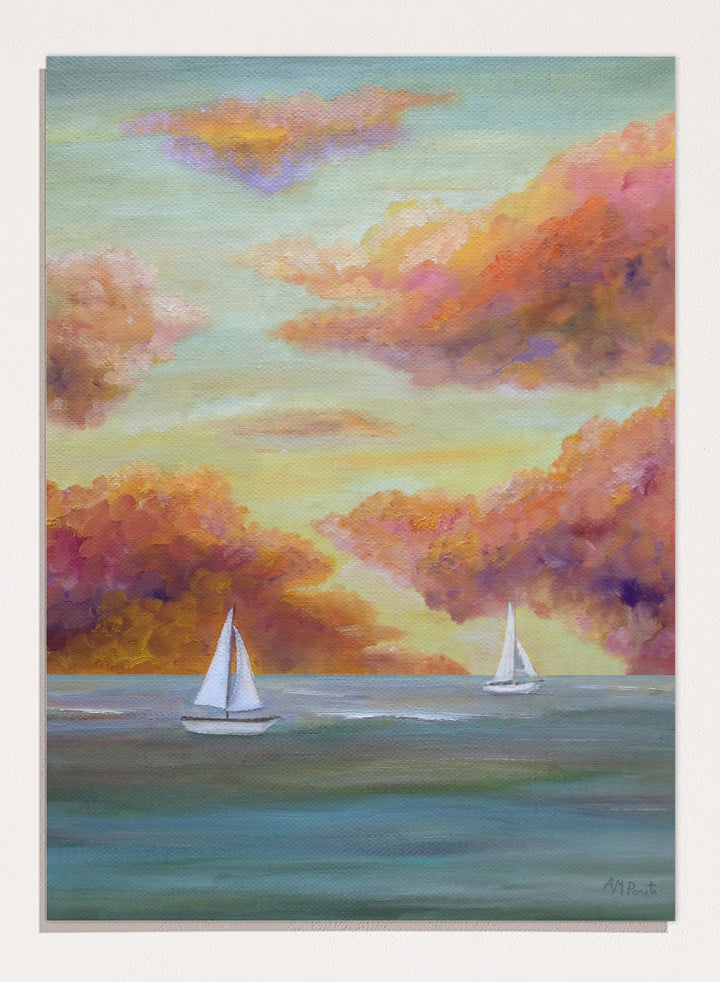 A framed painting of two white sailboats on a calm blue-green sea under a sky filled with soft, painterly clouds in pink, orange, yellow, and purple tones. Shop Sailboat Sunset Sky by Angeles M. Pomata, a coastal landscape art print featuring sailboats, calm water, and a glowing sunset sky.