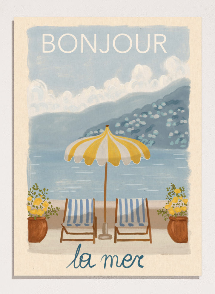 A vintage-style illustrated poster or print showing a beach scene with two striped lounge chairs under a yellow-and-white umbrella, potted plants, blue water, and mountains in the background. The words &