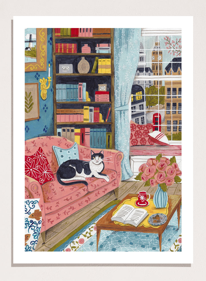 Illustration of a cozy living room with a cat on a pink sofa, bookshelf, and coffee table. Cozy London Cat by Caroline Bonne Müller is a fine art print and wall poster featuring a cat lounging in a colorful living room with a London city view.