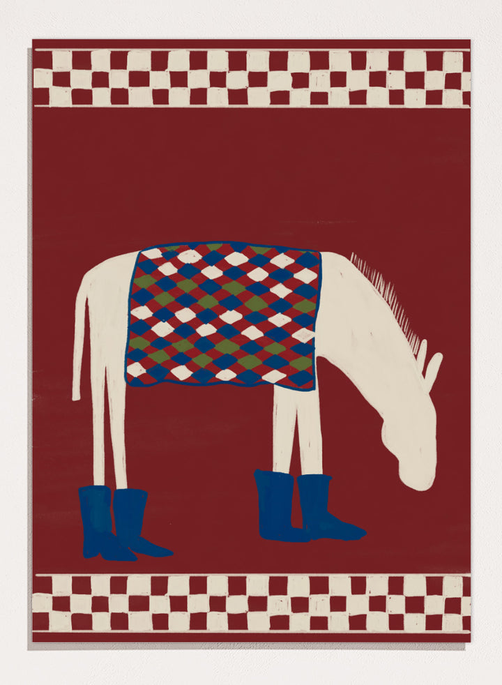 A stylized folk-art illustration of a white horse with a patterned blue, green, and red saddle blanket and blue boots, set against a dark red background with cream-and-red checkered borders at the top and bottom. Whimsical Donkey In Boots by The Art Concept animal art print featuring a white donkey in blue boots with a patterned blanket and rich red background.