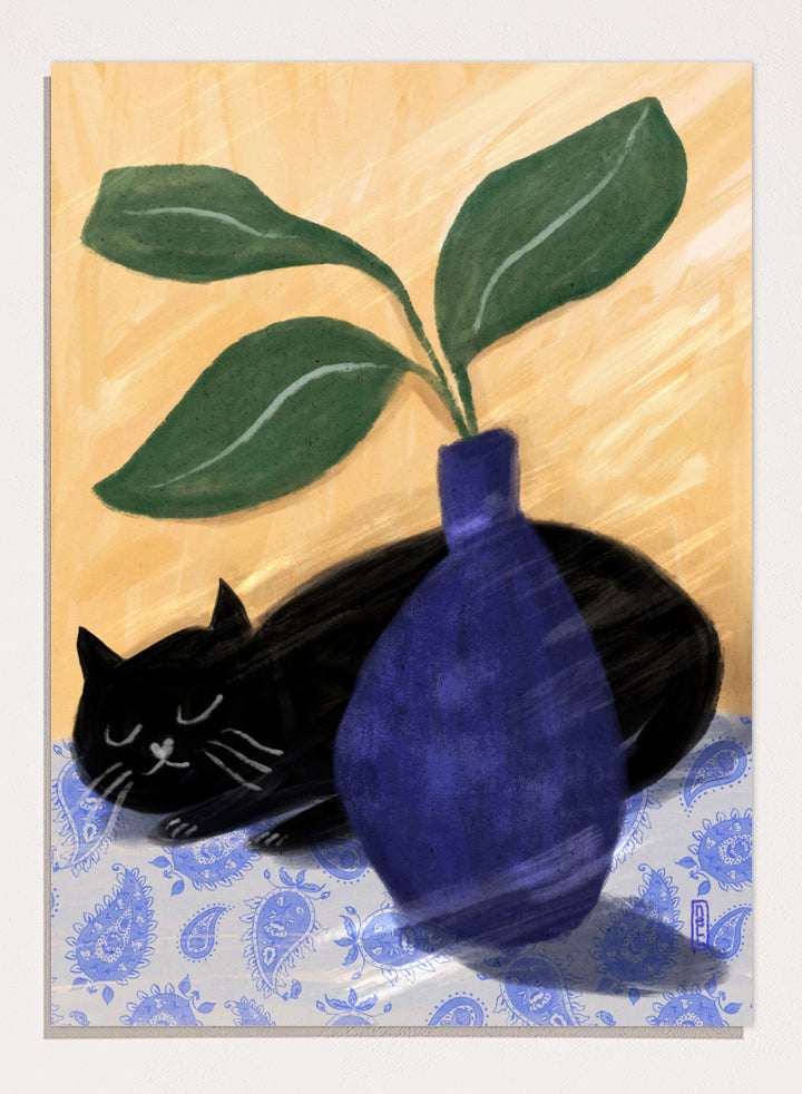 A stylized still life painting featuring a black cat lying on a blue-and-white patterned surface beside a dark blue vase with green leaves, against a warm beige background. Shop the Sleeping Black Cat art print by Dirkie Nell, featuring a curled black cat, bold cobalt blue vase, green leaves and playful patterned details.
