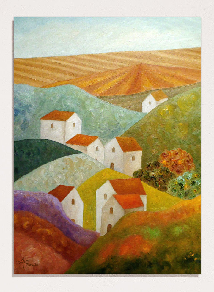 A colorful landscape painting featuring white houses with orange-red roofs nestled among rolling hills in shades of green, purple, yellow, and orange, with a plowed field under a pale sky in the background. Shop Colorful Hillside Village by Angeles M. Pomata, an autumn countryside art print featuring white houses, rolling hills, warm fields, and earthy color.
