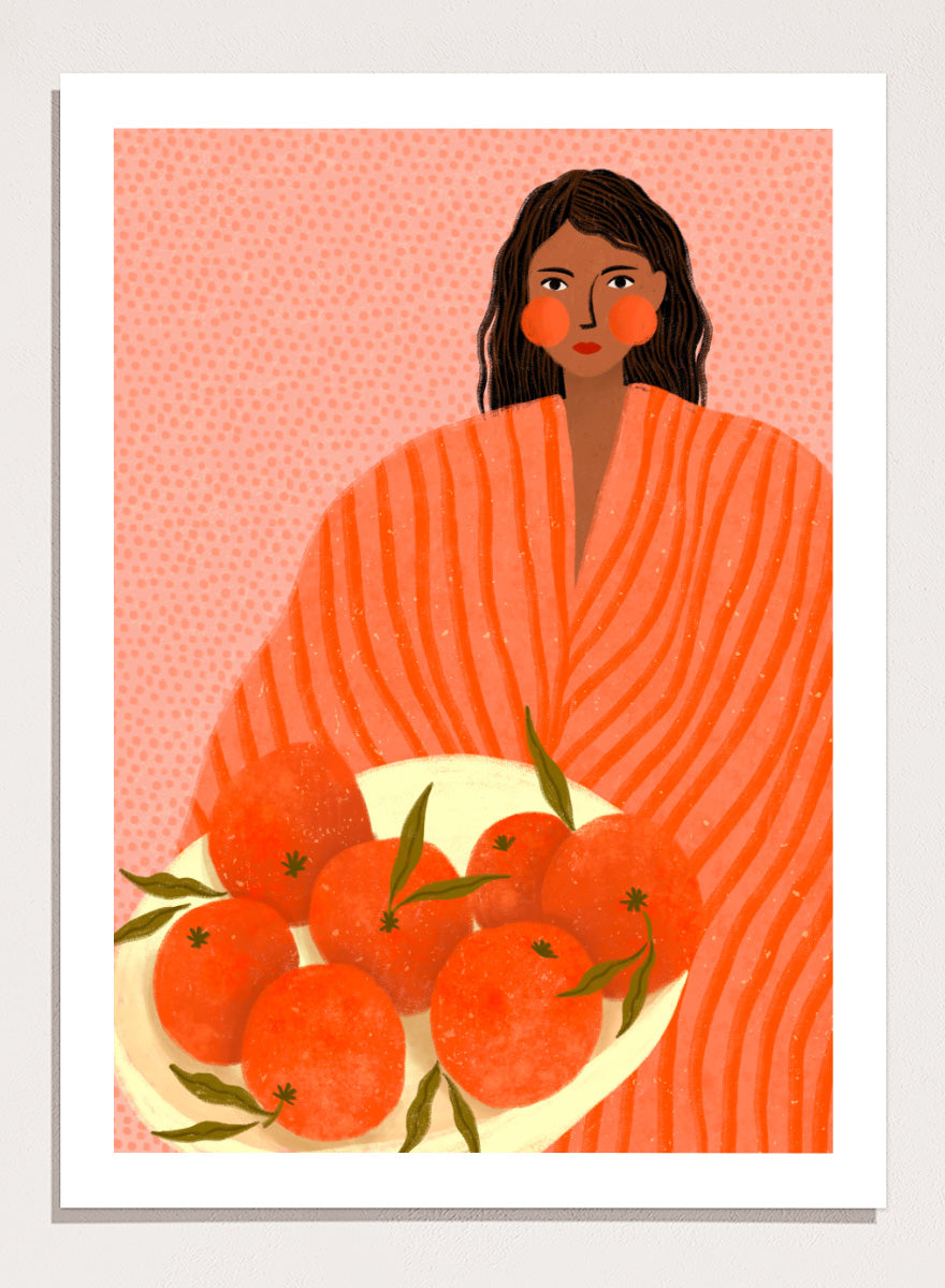 A stylized art print featuring a woman with dark hair wrapped in a bright orange striped blanket, holding a white plate of oranges against a pink dotted background. Woman Holding Oranges by Bea Müller colorful kitchen art print featuring a woman carrying fresh citrus fruit in warm orange and coral tones.