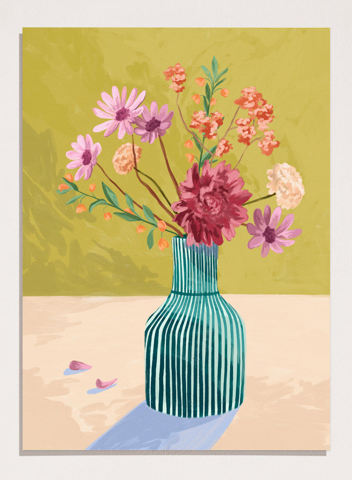Vase with flowers on a table against a green background. Wildflowers by Goed Blauw is a colorful floral art print and wall poster featuring a striped vase with loose flowers on a warm yellow background.