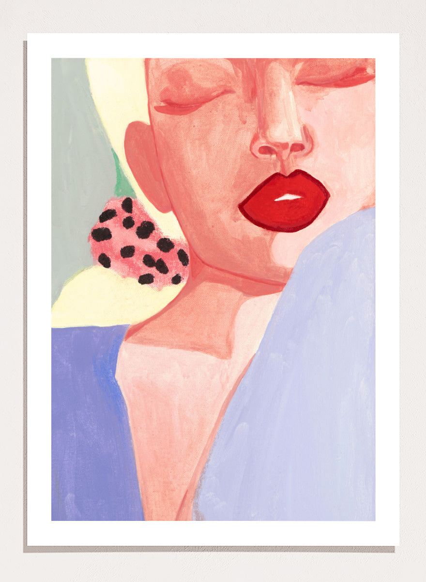 Shop Red Lips by Sophia Novosel, a modern woman portrait wall art print poster featuring bold red lips, closed eyes, soft pink tones, and a spotted earring.