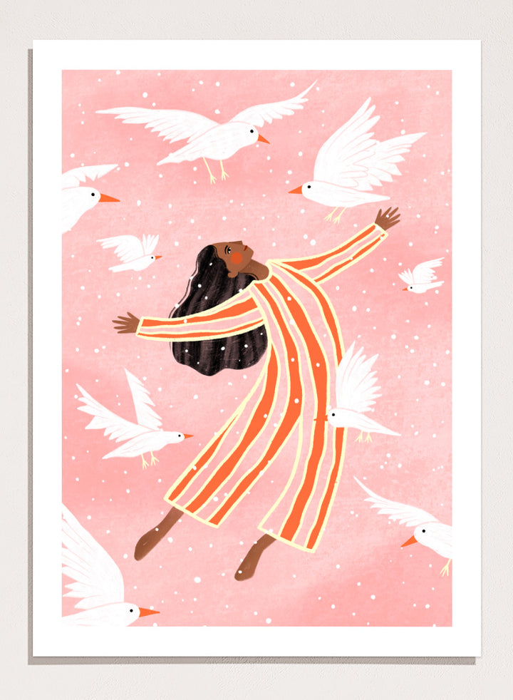 A framed art print featuring an illustration of a woman in orange and white striped pajamas floating among white doves on a soft pink background. Joyful Liberation by Bea Müller woman art print featuring a free-spirited figure surrounded by white birds in bold pink and orange tones.