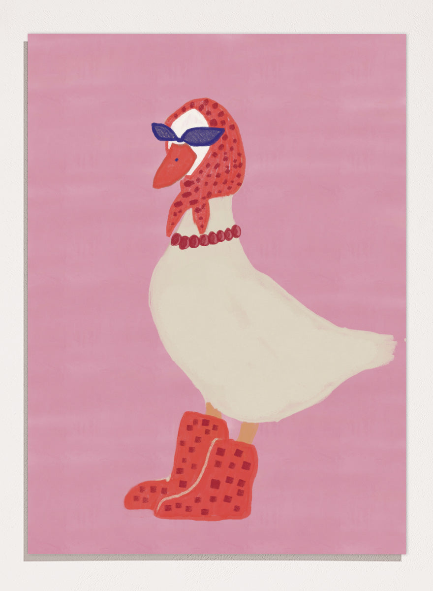 A stylized illustration of a white goose wearing a red patterned headscarf, blue sunglasses, a red beaded necklace, and red checkered boots, set against a solid pink background. Chic Goose Fashion by The Art Concept playful animal art print featuring a goose in sunglasses, a red headscarf, necklace, and bold red boots.