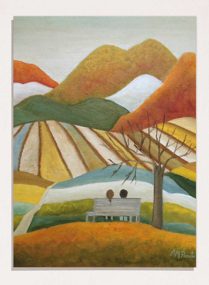 A stylized landscape painting with layered mountains, terraced fields, a bare tree, and two small figures seated on a bench in the foreground. Shop Couple On Autumn Bench by Angeles M. Pomata, an autumn landscape and figurative art print featuring a seated couple, rolling hills, patchwork fields, and warm fall tones.