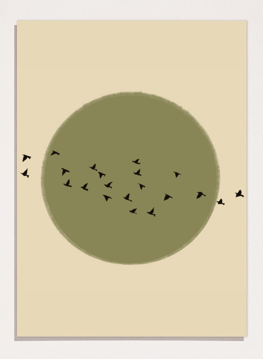 Minimalist art print featuring a large olive green circle with small black bird silhouettes flying across it, set against a warm beige background. Graceful Birds Soaring by The Art Concept is a minimalist bird art print featuring black birds in flight across an olive green circle and warm cream background.
