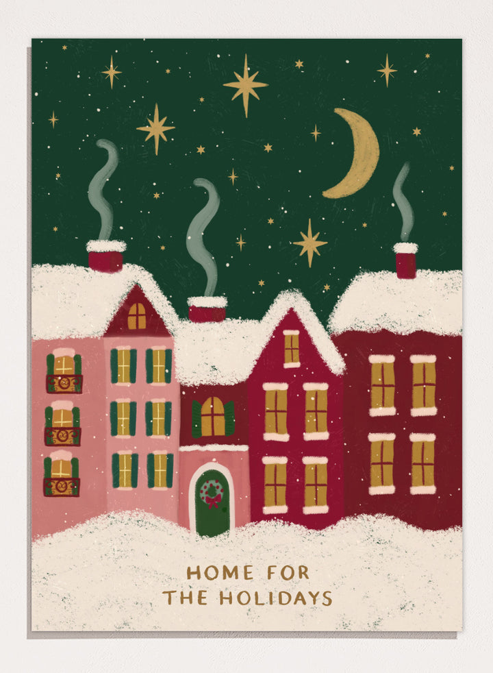 Shop Home For The Holidays by Katarzyna Gąsiorowska, a Christmas wall art print poster featuring snowy houses, glowing windows, stars, and a cozy winter village scene.