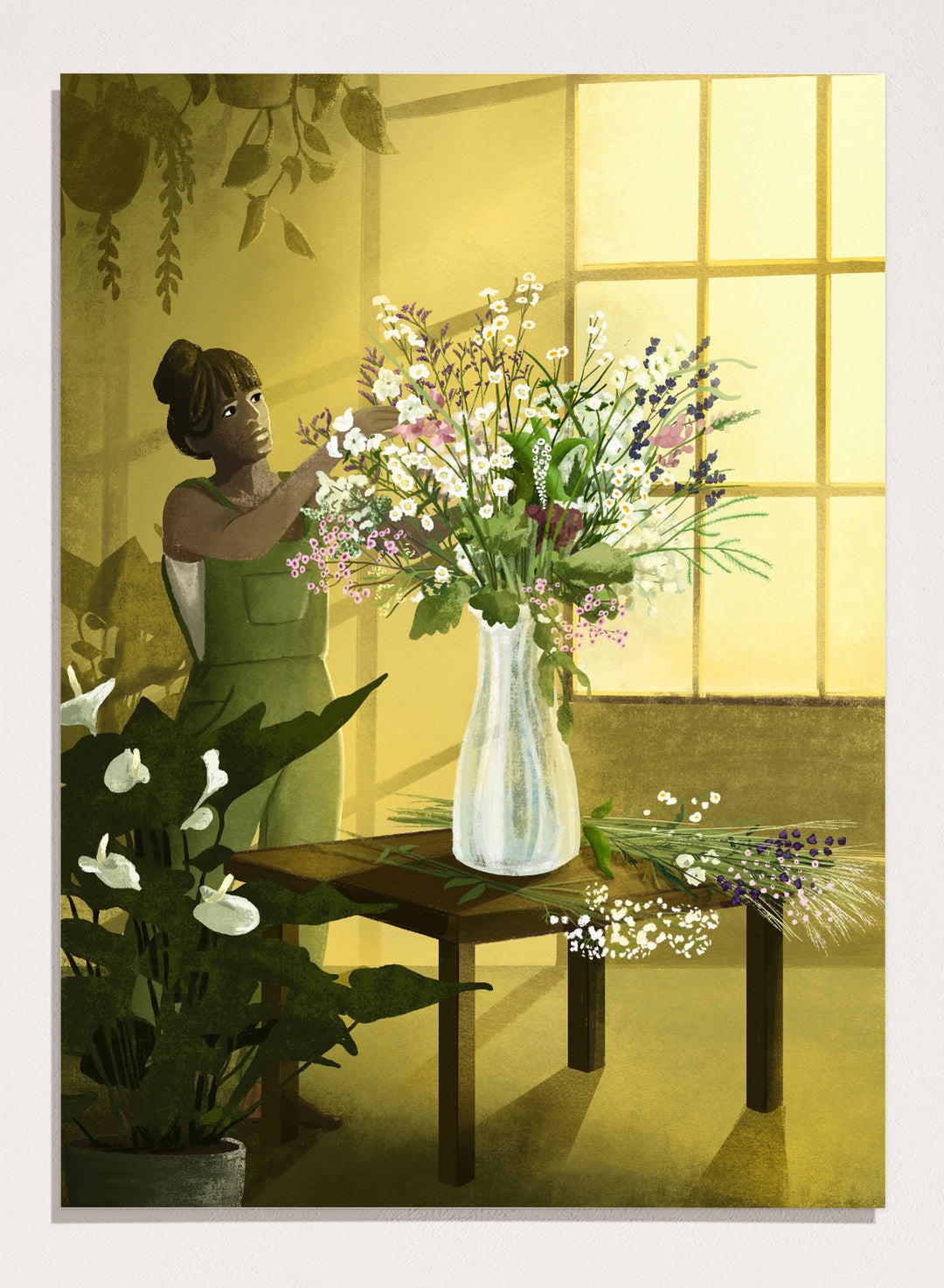 Woman in a green dress holding a bouquet of flowers in a softly lit room. In the Cracks of Light I Dream by Goed Blauw is a floral art print and wall poster featuring a woman arranging flowers in warm window light.