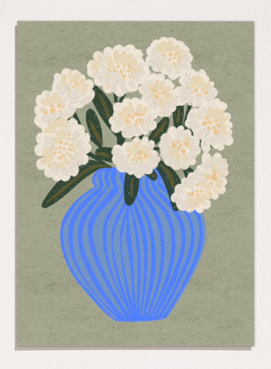 A stylized floral artwork showing a bouquet of off-white flowers with dark green leaves in a blue ribbed vase against a muted sage background. Shop White Blooms Blue Vase by Nikita Jariwala, a floral wall art print poster featuring white flowers in a striped blue vase with modern botanical style.