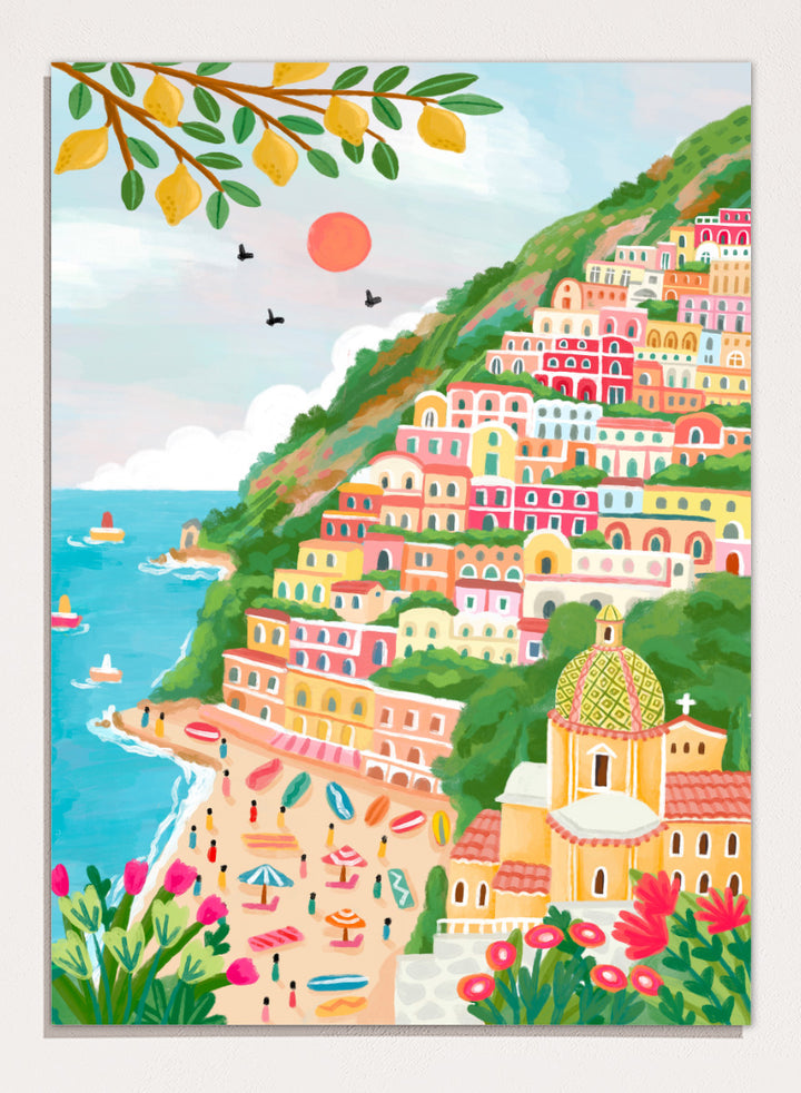 A colorful illustration of a coastal hillside town with tiered pastel buildings, a beach, blue sea, green foliage, and a church dome. Shop Vibrant Seaside Town by Nidhi Kachhadiya, a colorful coastal wall art print inspired by an Italian cliffside village, beach views, and bright Mediterranean color.