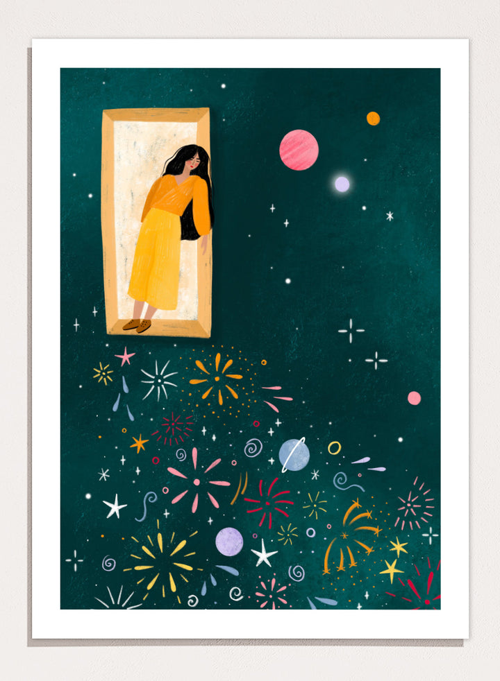 A framed art print featuring a whimsical illustration of a woman in a yellow dress standing in a mirror, with her reflection spreading colorful fireworks and space-themed motifs like planets and stars across a dark teal background. Shop Girl and Cosmic Fireworks by Bea Müller, a figurative wall art print poster featuring a woman, planets, stars, and colorful cosmic fireworks in deep green tones.