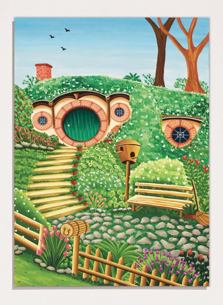 A colorful fantasy-style illustration of a hobbit hillside scene with a round green door, stone steps, flowers, trees, a bench, and a birdhouse under a blue sky. Shop Whimsical Hill House by Nidhi Kachhadiya, a colorful cottage wall art print featuring a garden home, lush greenery, flowers, and playful storybook details.