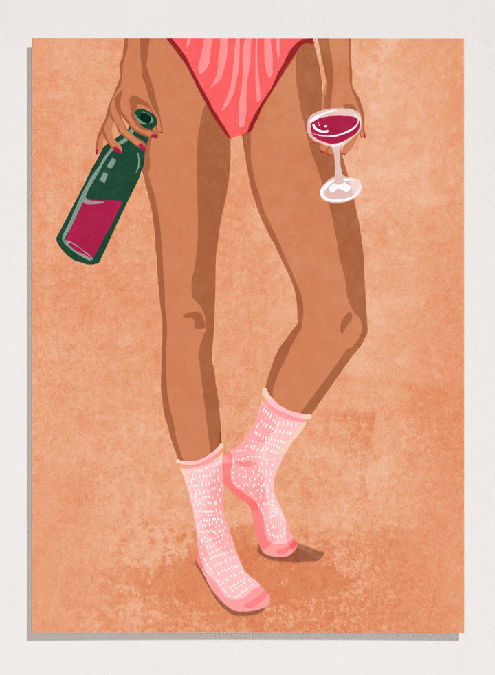 Illustration of a person's legs wearing pink socks with text, holding a bottle and a glass on a peach background. Wine and Socks by Raissa Oltmanns is a modern woman art print featuring wine bottle and glass in bold contemporary wall poster style.