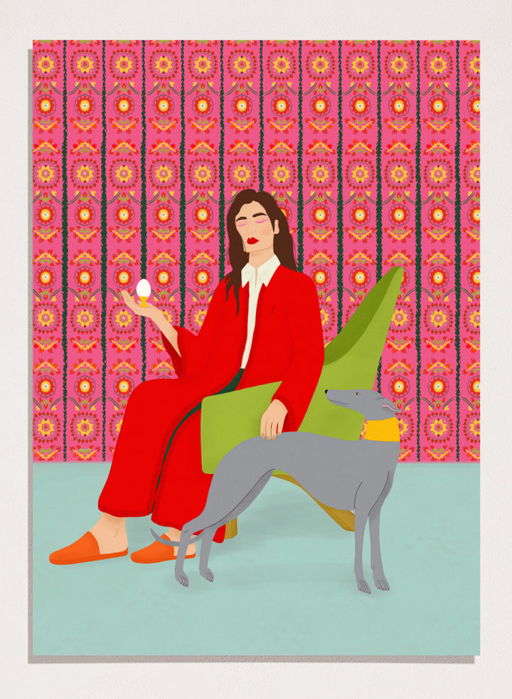 Woman in a red coat sitting on a green chair with a dog, against a pink patterned wall. Wonderful Egg by Jota de Jai is a whimsical modern art print of a woman in a red robe holding an egg with her greyhound, officially licensed wall poster with framing.