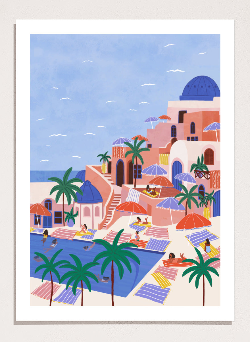 A stylized art print depicting a Mediterranean resort scene with palm trees, beach umbrellas, lounge chairs, a swimming pool, and pastel-colored buildings under a light blue sky. Mediterranean Poolside Retreat by Ceyda Alasar travel art print featuring a colorful coastal resort, palm trees, sunbathers, striped umbrellas, and sea views.