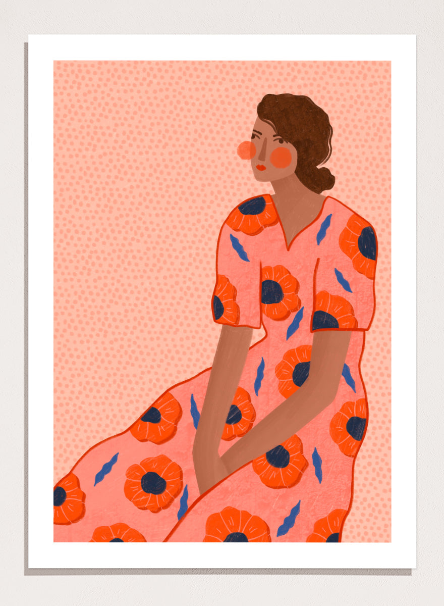 A stylized fashion illustration of a seated woman in a coral pink dress with large orange poppy motifs and blue leaf accents, shown with a white border and black frame. Stylish Poppy Portrait by Bea Müller floral woman art print featuring a pink dress covered in orange poppies and blue leaves for colorful modern wall decor.
