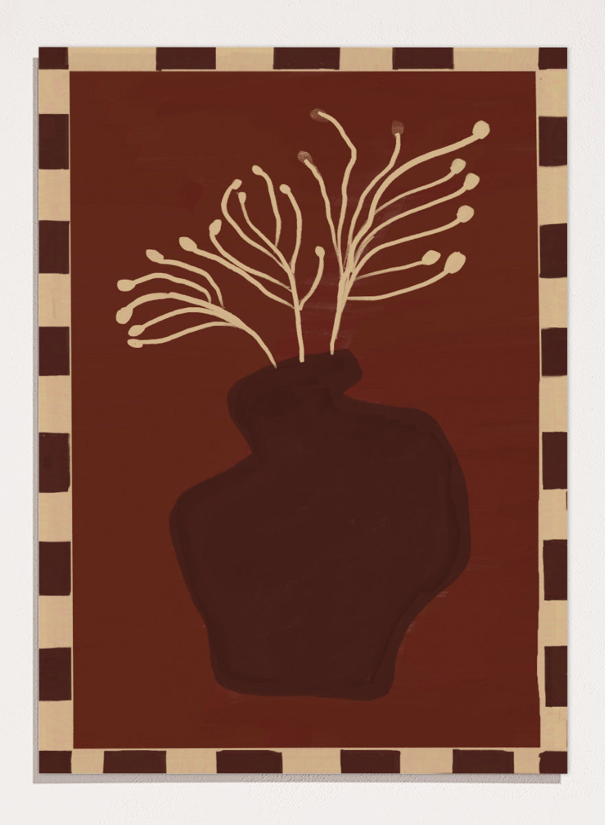 An art print featuring a dark brown abstract vase with cream branching stems on a deep reddish-brown background, framed by a beige and dark brown checkered border. Minimalist Vase Plant by The Art Concept still life art print featuring a dark vase, cream stems, checkerboard border, and warm rust-brown tones.