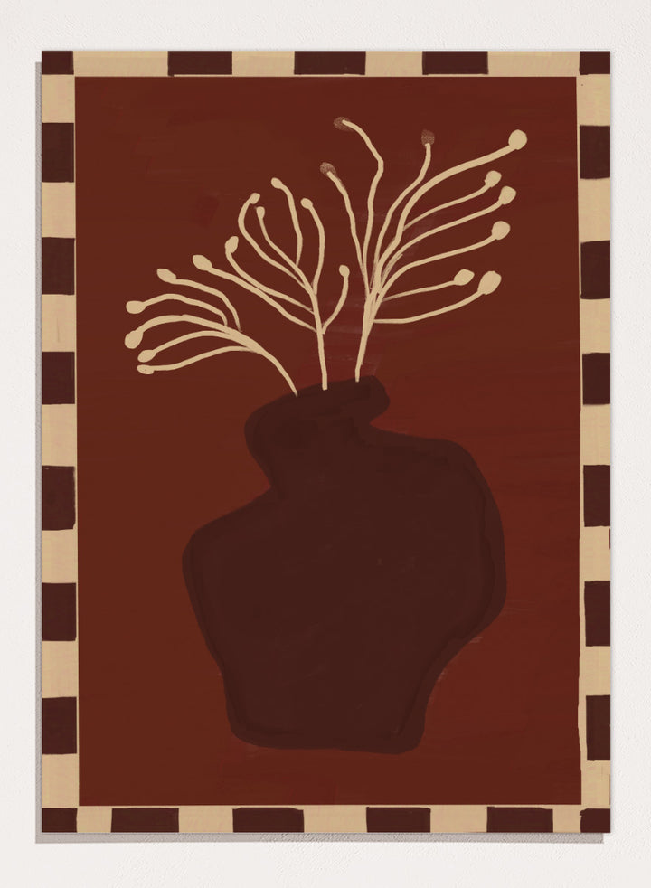 An art print featuring a dark brown abstract vase with cream branching stems on a deep reddish-brown background, framed by a beige and dark brown checkered border. Minimalist Vase Plant by The Art Concept still life art print featuring a dark vase, cream stems, checkerboard border, and warm rust-brown tones.