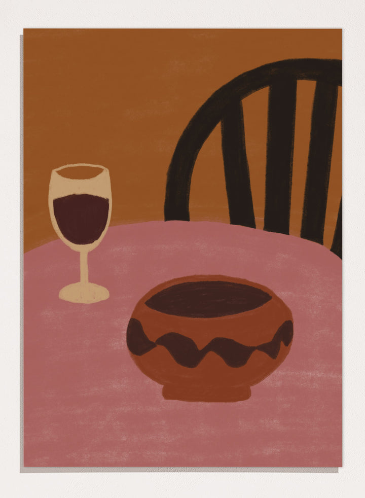 A stylized still life artwork showing a pink table, a dark brown bowl in the foreground, a wine glass with deep red liquid, and a black chair against a warm brown background. Warm Dining Still Life by The Art Concept still life art print featuring red wine, a rounded bowl, pink tabletop, and rich burgundy and rust tones.